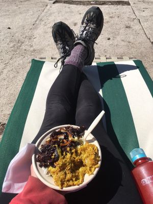 Delicious eggplant moju curry with rice, cabbage, & dal, on a beautiful sunny spring day. at Moab Kitchen in Moab