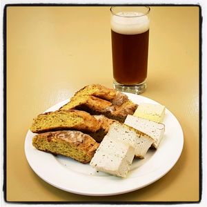 A crispy pumpkin baguette with a selection of cashew cheeses, including Pesto, Curry, Larb and Lemon Turmeric, washed down with an Amber Ale... Delicious!! at Barefood Bangkok in Bangkok