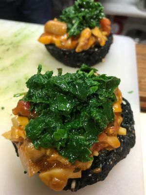 Porcini sauce over crisp bagel and top with poached Kale. at Barefood Bangkok in Bangkok