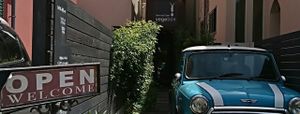 Shopfront. The premises themselves are tucked away from the street. The blue Mini Cooper would serve as an landmark. at Oso-zai Cafe Vegebon in Tokyo