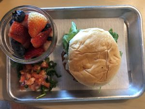 Vegan Farmhand Kchn burger with a side of fruit at FarmHand Kchn in St Augustine