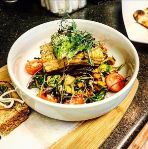 Tofu Bowl | seasonal greens | tomato | portabella |shaved brussel sprouts | daikon radis | sprouted 7-grain toast | hemp hearts  at FarmHand Kchn in St Augustine