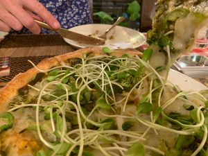 Pesto pizza with gooey vegan cheese, broccoli, and bean sprouts - a solid, yummy pizza. at Rad Rabbit in Chiang Mai