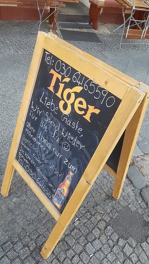 Information outside saying that food is available for take-away after pre-ordering by phone. at Veggie & Vega - Restaurant in Berlin