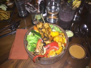 Dragon bowl with tofu skewers and purple “extreme green smoothie” (spirulina, dates, coconut water, banana, blueberries) at Kismet Restaurant & Lounge in Ubud