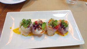 example of first course from the menu - vegetable rolls in rice paper with a tasty sauce at Strata Bakery in Barcelona