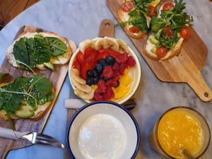 Avocado toast with vegan cheese, granola anf fruit bowl with vegan yogurt at Strata Bakery in Barcelona