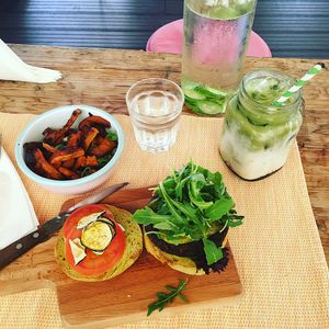 Burger, sweet potato fries, matcha milk at Seva Table in Dubai