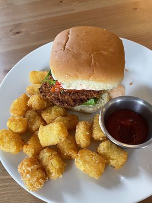 Cajun Chix Sandwich with tater tots   at Kahiau's Bakery & Cafe in Virginia Beach