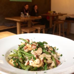 Lemony green beans with whole grain califlower gnocchi and fermented garlic dijonese at zralé bistro in Zlin