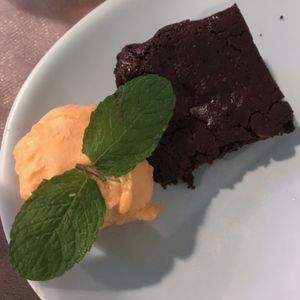 Vegan chocolate-orange brownie with orange sorbet. So yummy!! at Rotas da Ilha Verde in Sao Miguel