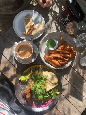 Vegan falafel wrap from the display, a tasting platter veganized, sweet potato chips and coffee. at Garden Grub Cafe in Wingham
