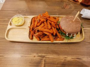 Squash Burger with sweetpotatoe fries and spicy vegan cheese dip  at Tökmag Vegan Street Food in Budapest