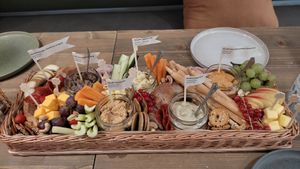 Appetizer baskets - hummus, eggplant spread, vegetable spread, gluten free sourdough bread, crackers, nachos, fruits, vegetables and nuts  at Tökmag Vegan Street Food in Budapest
