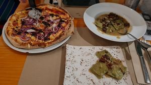 Pizza Trufata y Raviolis rellenos de alcachofa y cebolla caramelizada at Pizzi & Dixie in Madrid