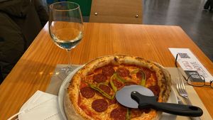 Pepperoni pizza that’s completely vegan. I paired it with the sweet white wine!  at Pizzi & Dixie in Madrid