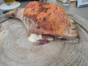 Calzone veg with vegan mozzarella, vegan gorgonzola, vegan salame and red onions. at Birra & Farina in Castelletto Sopra Ticino