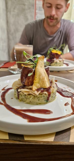 Chef's seasonal special. A traditional Slovenian dish with fermented turnip, unleavened bread, gravy, vegetable chips, and juicy marbles stake. at Bistro Maha in Ljubljana