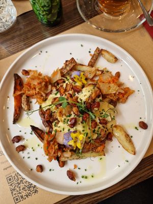 Loaded Potatoes with Kimchi, fried beans, buckwheat Tempeh, mustard cheesy sauce at Bistro Maha in Ljubljana