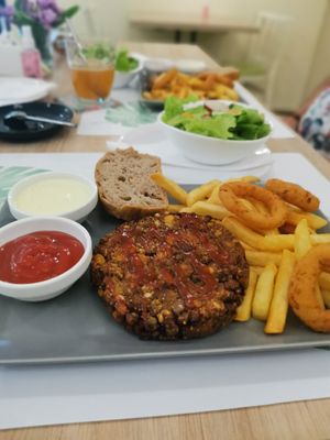 Yummy burger with fries and onion rings+ salad at Vege & Vegan  in Novi Sad