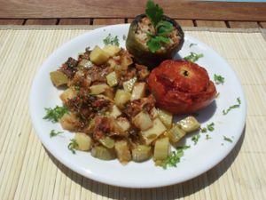 "Gemista" Tomatoes and peppers, stuffed with rice, in a fresh tomato sauce, served with diced potatoes and courgettes.
 at Talos Restaurant in Crete