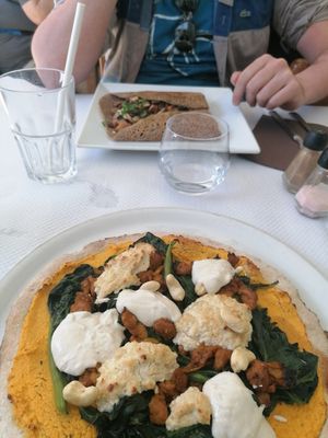 Vegan pizza with vegan ricotta, soy filet, cashews, spinach and more at Les Mille Poetes in Narbonne