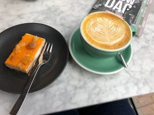 Curcuma latte with oat milk and vegan apricot/orange pie.  at Anne&Max in Arnhem