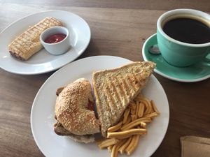 Sausage roll, sausage & bacon bagel + New York deli-style sandwich + americano  at 387 Ormeau Road in Belfast