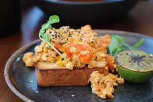 Korean Kimchi Tofu Scramble with toasted sesame seeds, charred lime. at Cafe Diversity in Moreton Bay Region