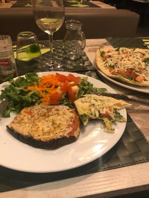 Eggplant parmigiana, pizza in background  at Nirvana in Florence