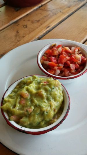 Chips come with guacamole, tomatoes, a small bowl of beans and 2 different hot sauces. at Wacamole in Punta Cana