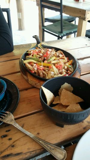 If you order the fajitas, you get 5 corn tortillas and the vegetables (onions, bell pepper, zucchini, eggplant) come on a sizzling skillet.  at Wacamole in Punta Cana
