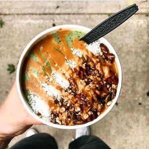 Our Grass Fed Smoothie Bowl loaded with healthy greens and avocado, & topped with house made granola, shredded coconut, and peanut butter sauce! at My Fit Little Foodie in Georgetown