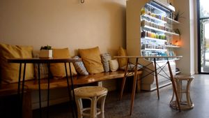 interior: cozy bark bench with pillows and circular tables at Local Juicery in Flagstaff