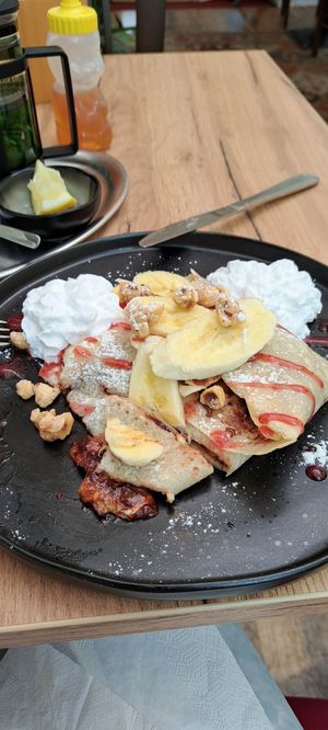 Spelt pancake with bananas, chocolate, toasted hazelnuts and a berry sauce at Natureza in Prague