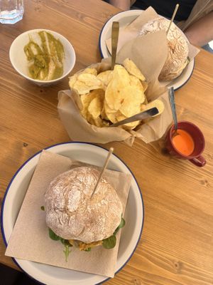 Vegan burger with potato fries and red sauce. Guacamole with crackers for starters.  at etel&pan in Fisterra