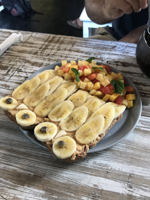 Peanut butter on toast with banana on top and a fruit salad  at Cafe Secret Alley in Kandy