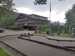 Exterior with playground at La Sarine - Hotel arc en Ciel in Gstaad
