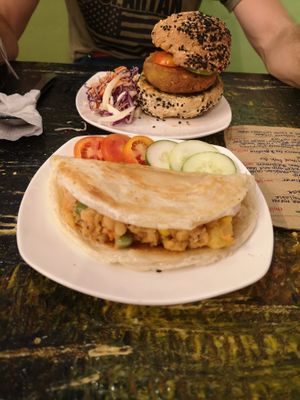 vegan burger in the back and samossa. Both were too dry. With a sauce it would be better. at Indah Cafe in Kuching