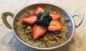 Ginger Berry Smoothie Bowl: Mixed berries, banana, fresh ginger and almond milk. Topped with house-made granola and fresh berries at Surya Cafe in Fitchburg