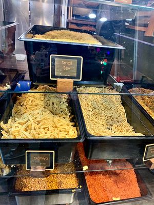 Surati Farsan - Cases of savory snacks (‘farsan’) at the counter. Try the sev! at Surati Farsan Mart in Artesia