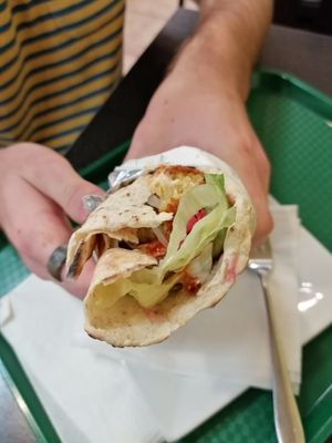 falafel wrap with hummus, tahini and hot sauce, salad at Delina's in Toronto