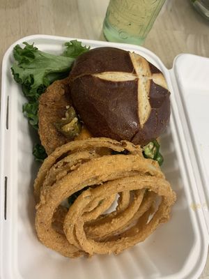 Fried chicken sandwich on a pretzel roll at Three Girls Vegan Creamery - Boston in Guilford