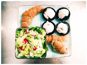 French vegan breakfast with 3 croissants, 4 different kinds of vegan cheeses and a fresh green salad with small radishs at Michelangelo Cafe in Tel Aviv