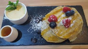 American style pancakes with maple butter and syrup gluten free with seasonal fruits at The Honest Vegan in Belfast
