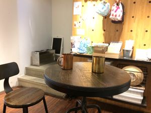 small seating area. two tables, 4 chairs. at HiPizza in Taipei