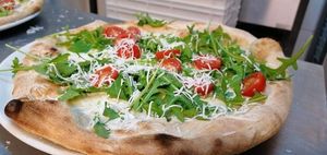 Vegan pizza with rucola, cherry tomatoes and vegan cheese at Marcellos of Douglas in Cork