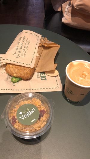 Nice vegan sandwiche with hummus, spinach, dried tomatoes and other stuff + chia pudding and granola + almond decaf latte ☺️ at CPH - Retreat - T2 in Copenhagen