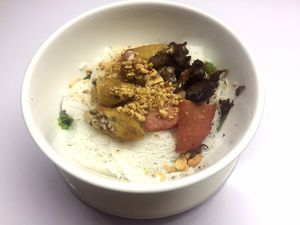 Cold noodles with spring rolls, mock ham and fried mushrooms.  at Sweet Root Vegetarian Restaurant  in Phnom Penh