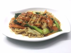 Khmer yellow noodles with vegetables and chili sauce.  at Sweet Root Vegetarian Restaurant  in Phnom Penh